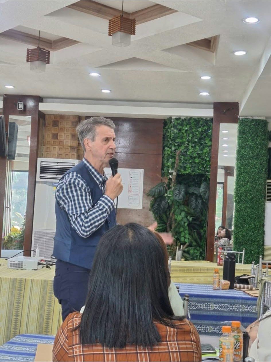 A speaker addressing people at an indoor gathering