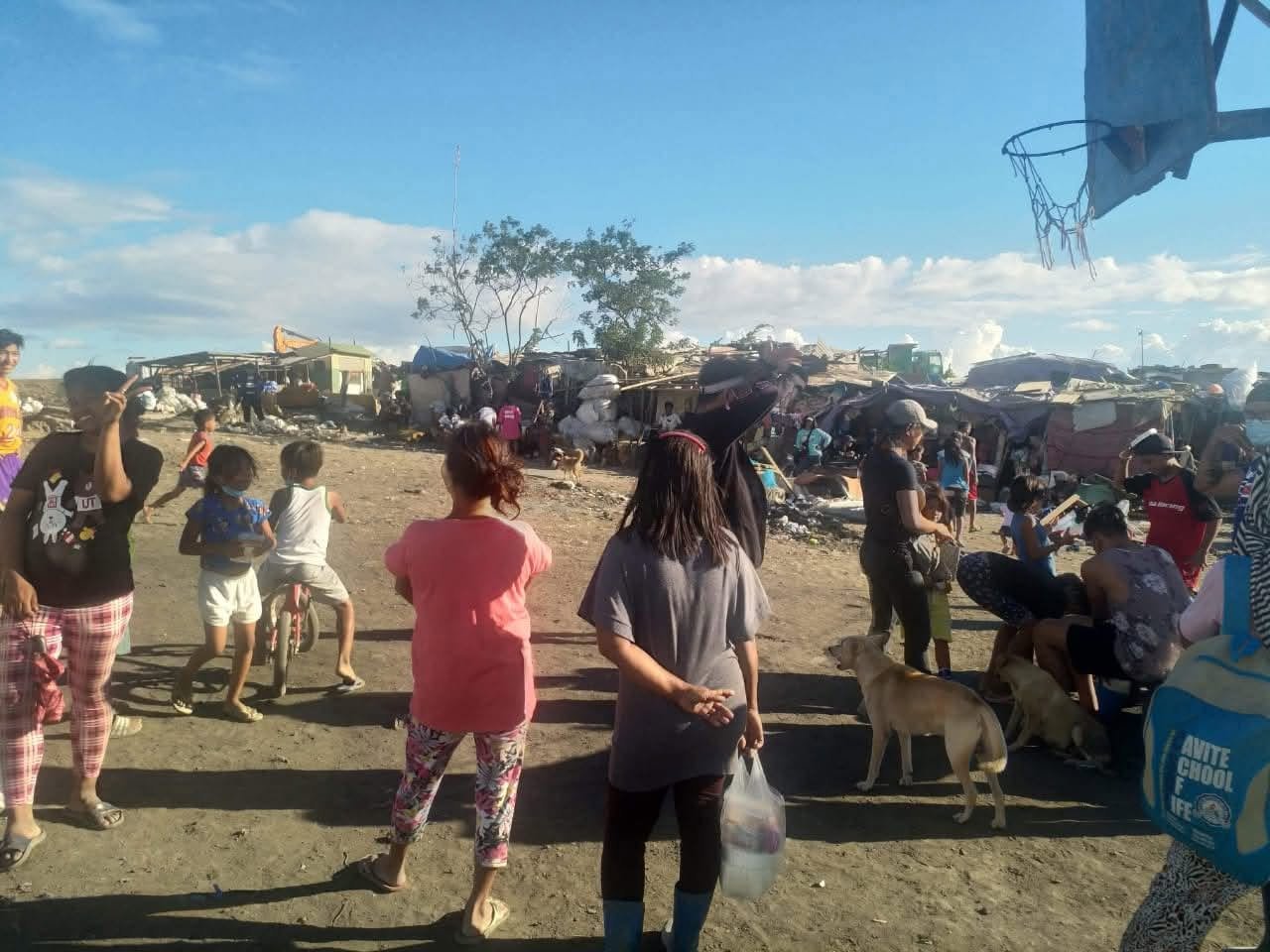 People gathered in a community area during relief distribution