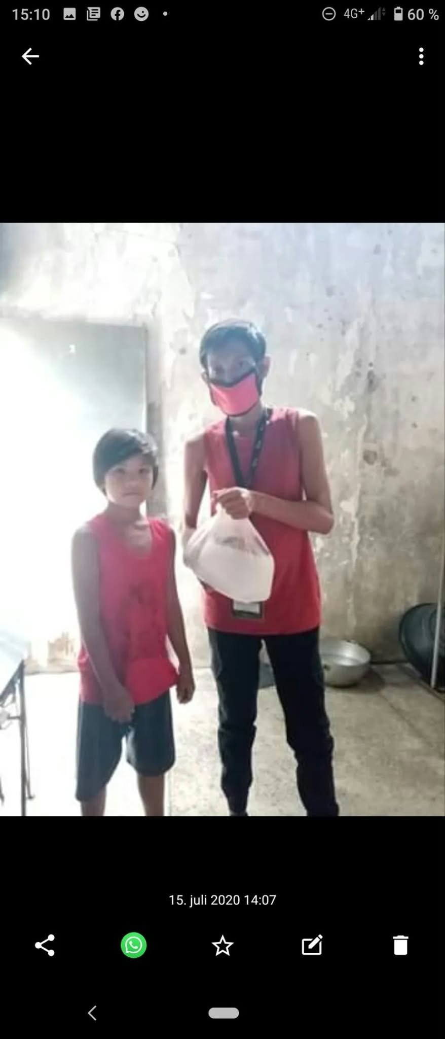 A person holding a bag of food with a child
