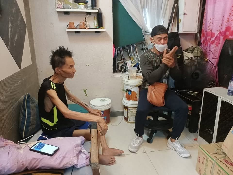 A volunteer seated with a man indoors