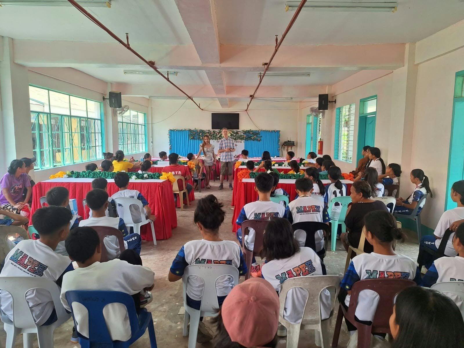 Audience and speakers at a community learning event