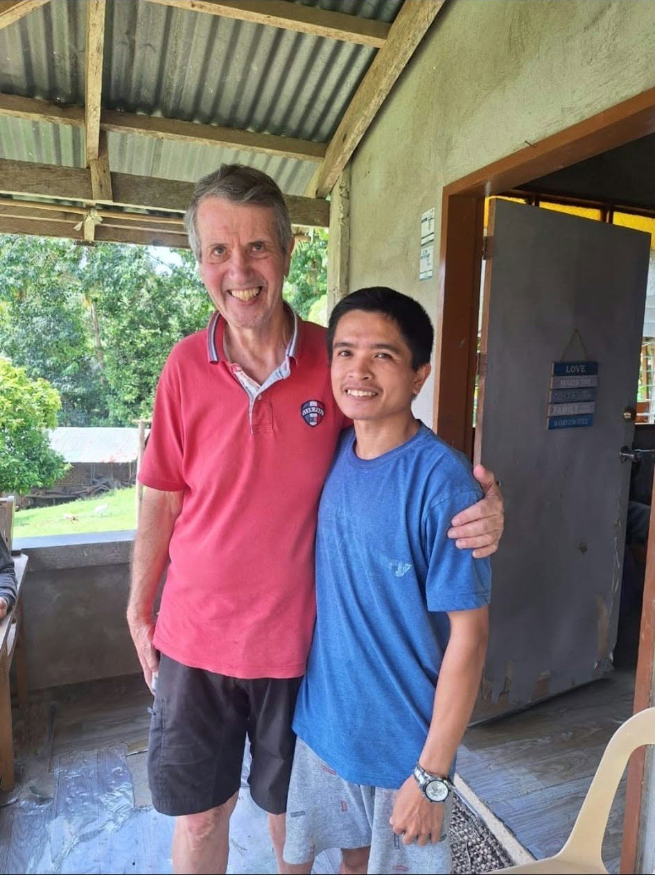Two people standing together during a visit